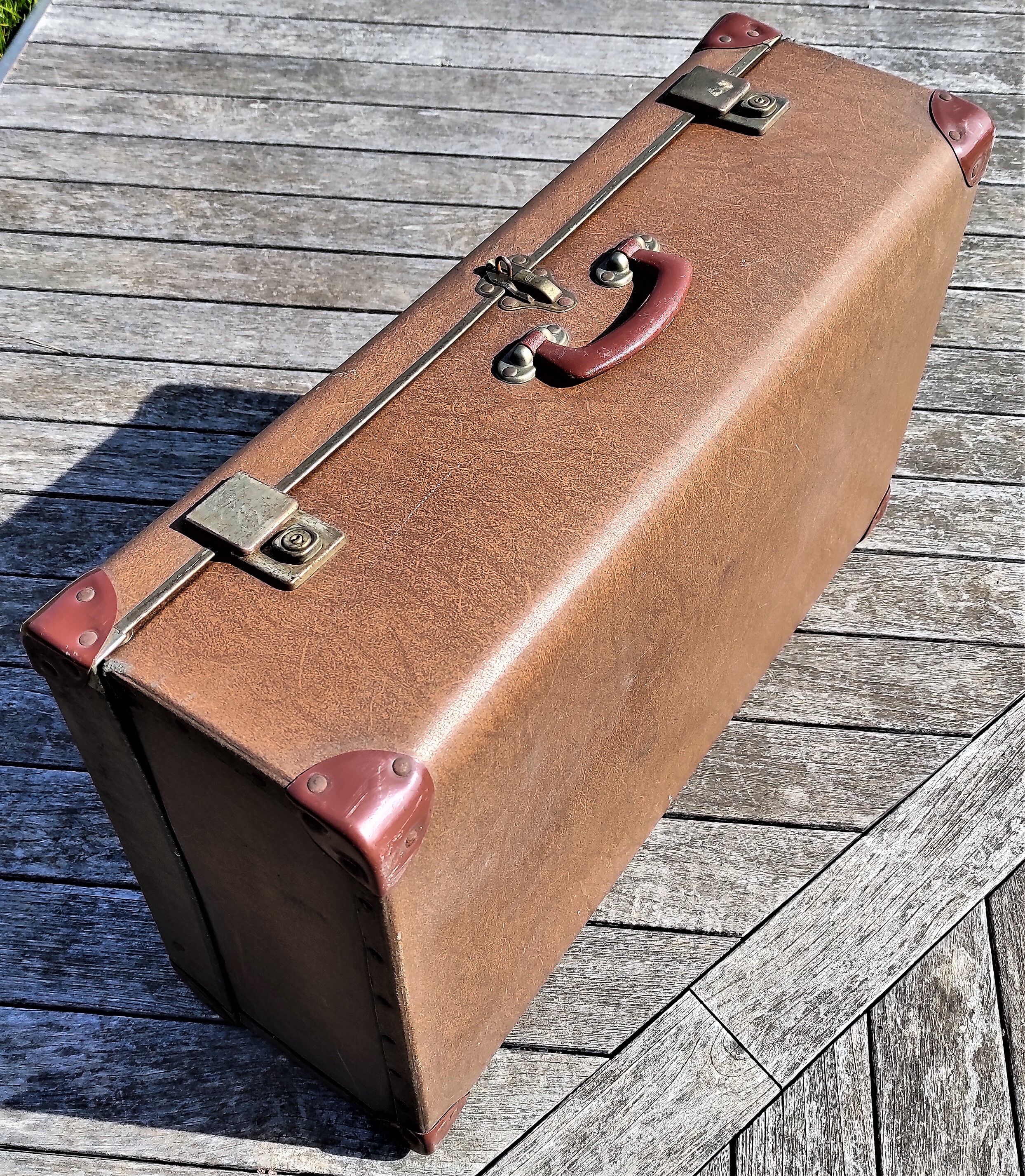 Brown vintage suitcase with CHENEY England brand travel tags