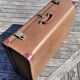 Brown vintage suitcase with CHENEY England brand travel tags