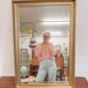 XL vintage bevelled mirror with a gold frame.