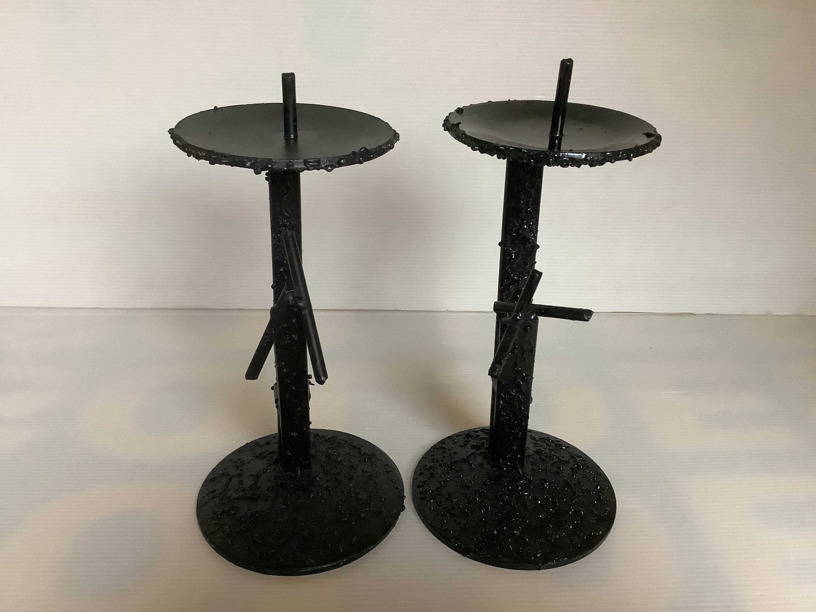 Pair of black metal candlesticks