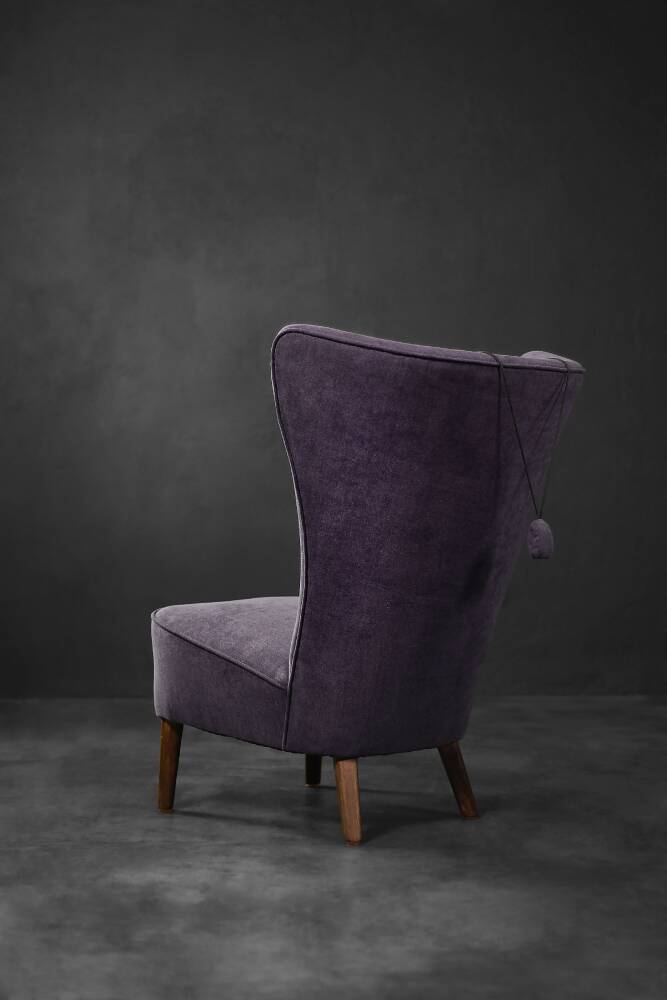 High-backed wing chair in oak and purple fabric, vintage Scandinavian style from the 1950s.