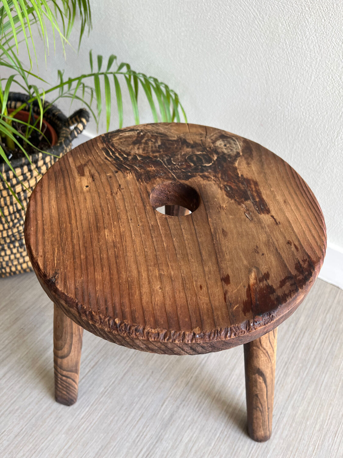Three-legged wooden stool
