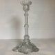 Thick moulded glass candlestick with fish and flowers.