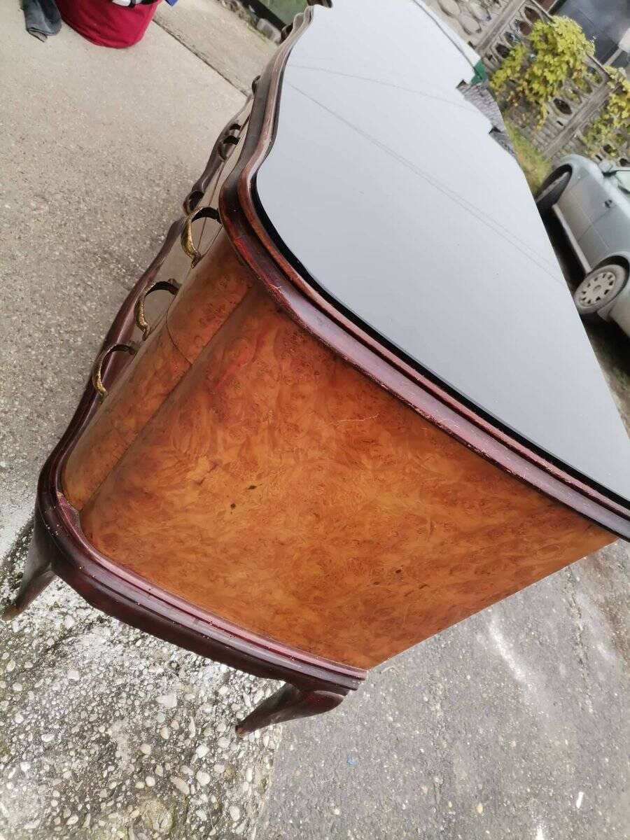 Mid-century Italian brown wooden chest of drawers, black glass top and brass handles.