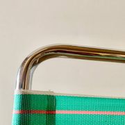 Vintage folding beach chair in chrome metal and woven plastic