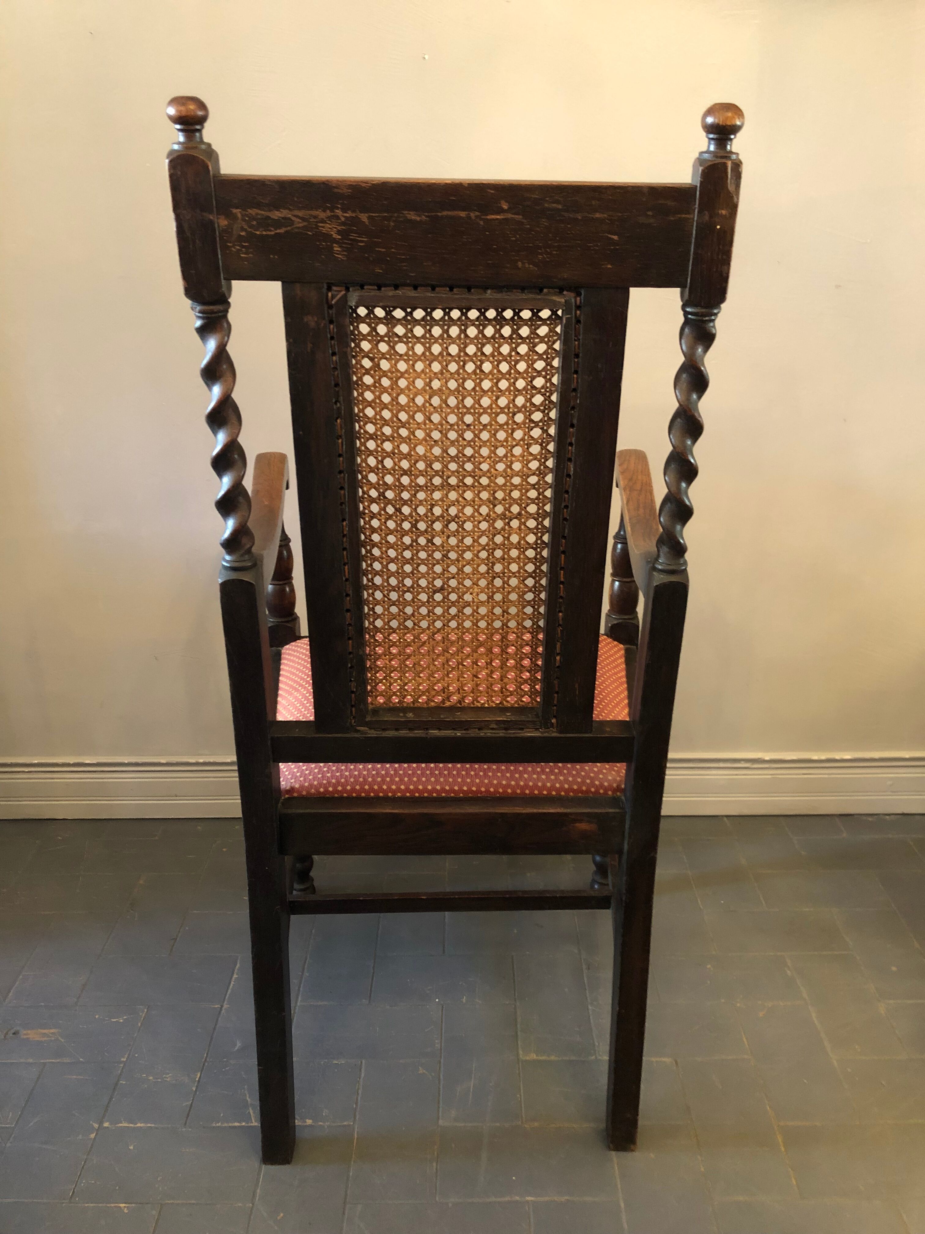 Carved wooden armchair and cannage
