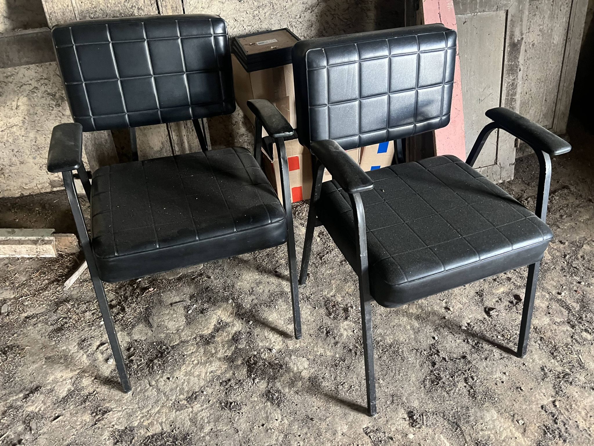 Pair of vintage industrial armchairs in black imitation leather and metal legs