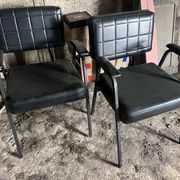 Pair of vintage industrial armchairs in black imitation leather and metal legs