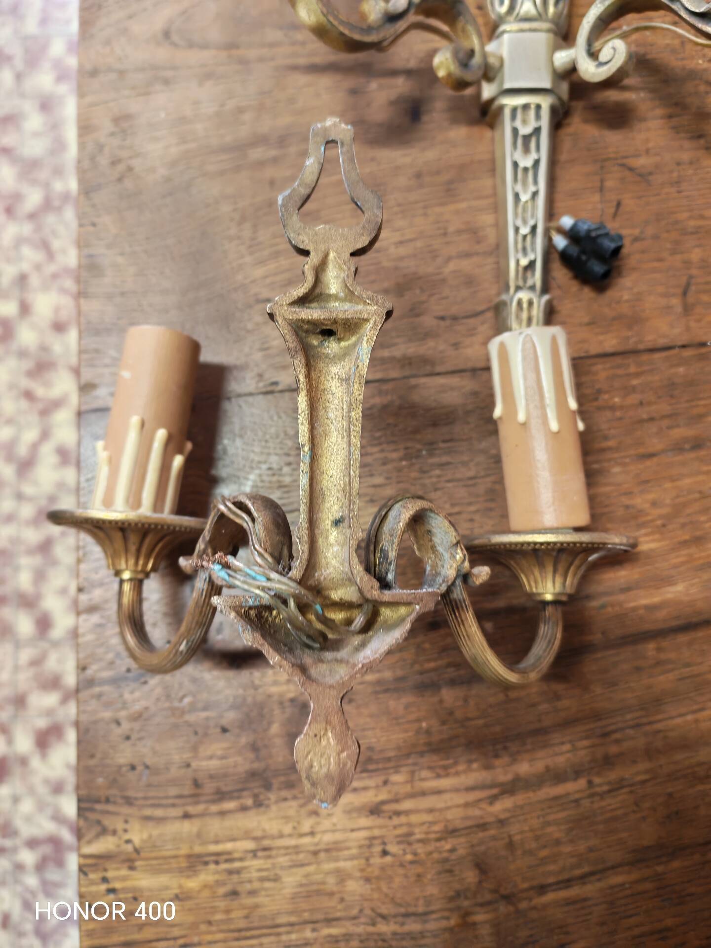 Two antique wall sconces in gilded bronze in the Louis XVI style.