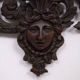 Miroir mural antique en bronze coulé représentant une tête de femme