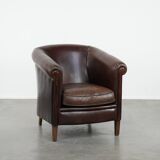 Stylish and sturdy dark brown club armchair made of sheepskin leather