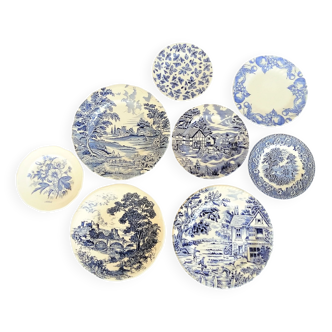 Eight mismatched blue and white plates