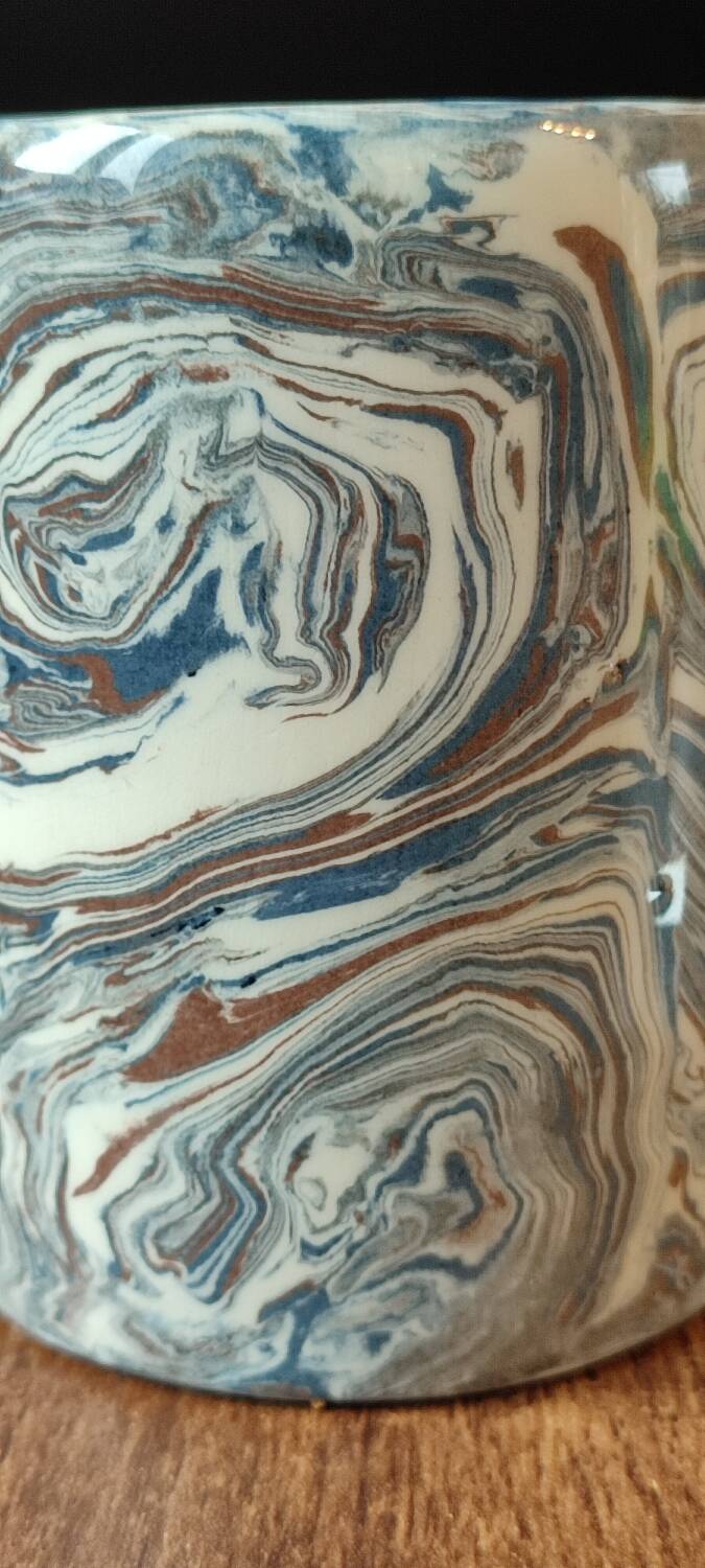 Handcrafted ceramic mug with marbled design, unique piece.