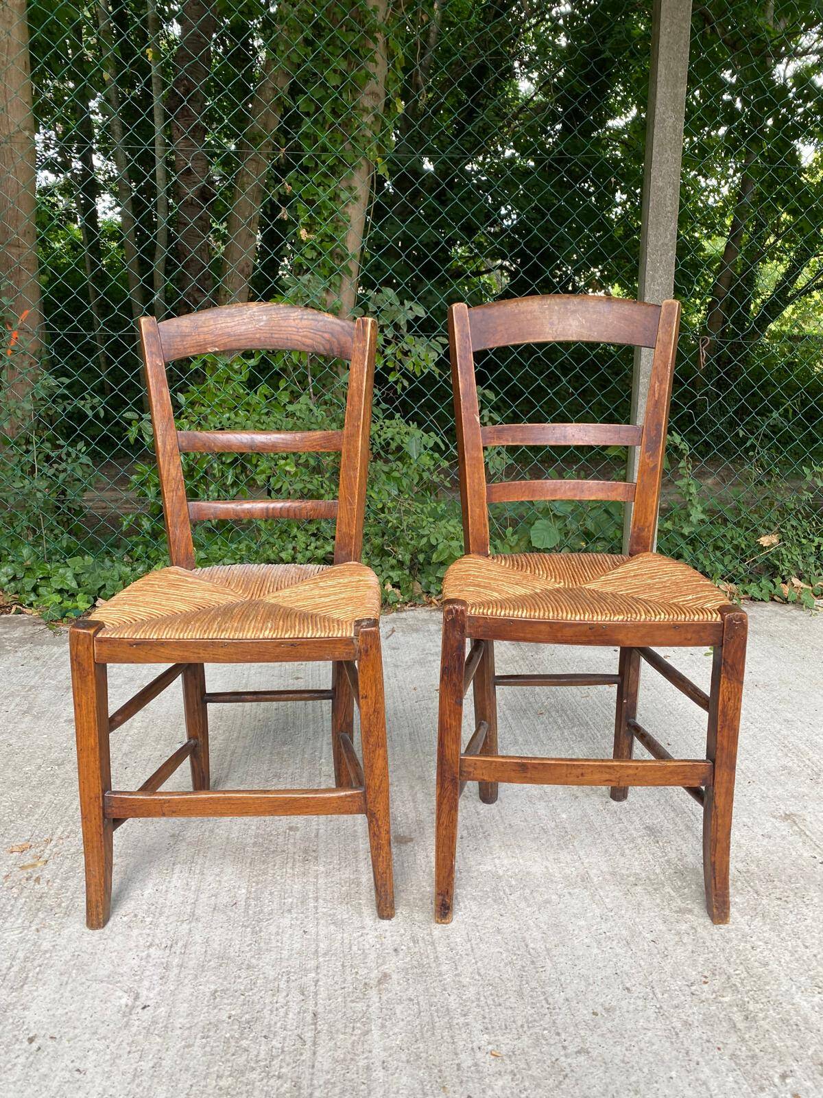 2 solid oak and straw wood chairs