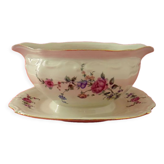 Cream-colored porcelain sauce boat with floral decoration