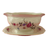 Cream-colored porcelain sauce boat with floral decoration
