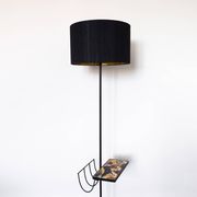 Black metal magazine rack floor lamp with ceramic shelf