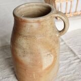 Old rustic stoneware jar with handle
