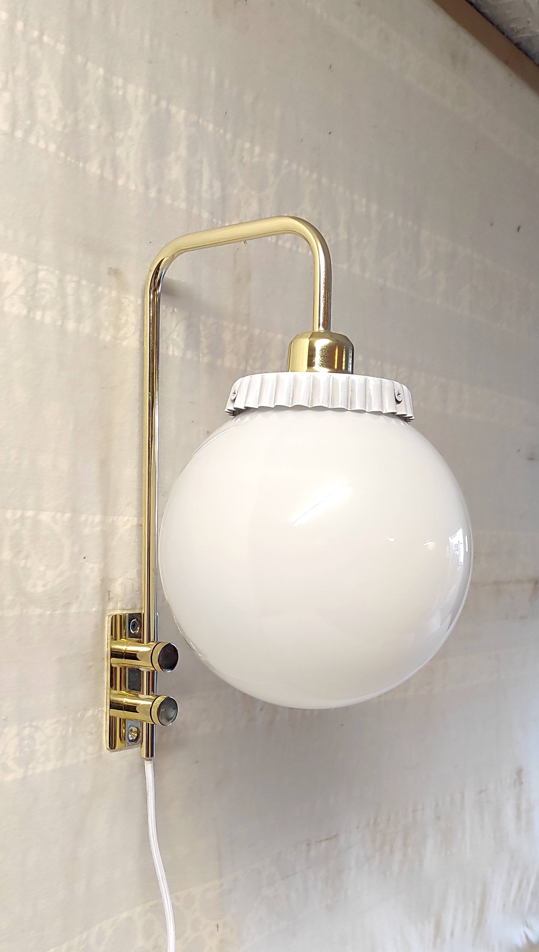 Opaline glass globe wall sconce with a gilt metal bracket - mid-20th century