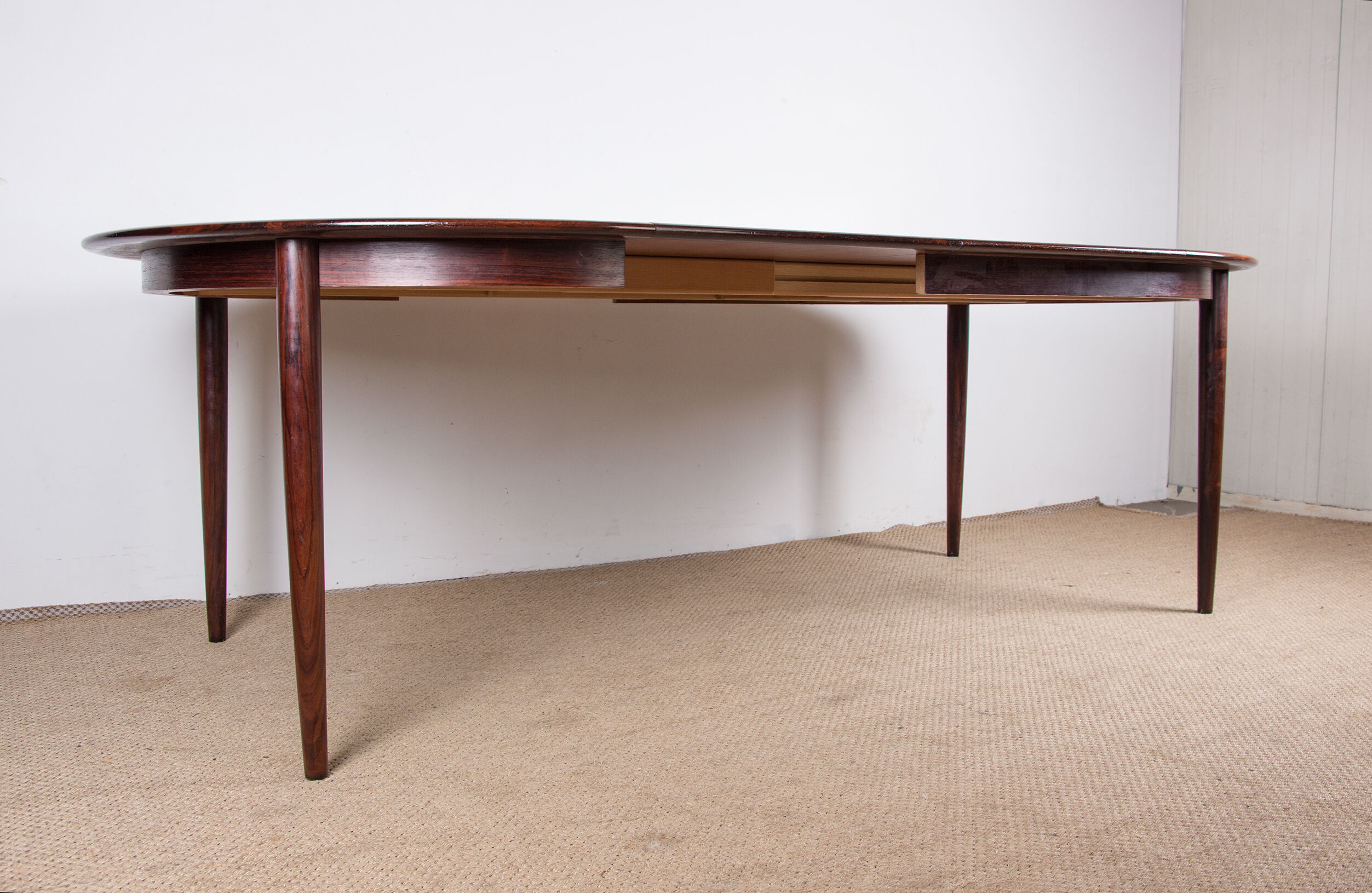 Danish extendable dining table in Rio Rosewood model 55 by Arne Vodder for Sibast 1958.