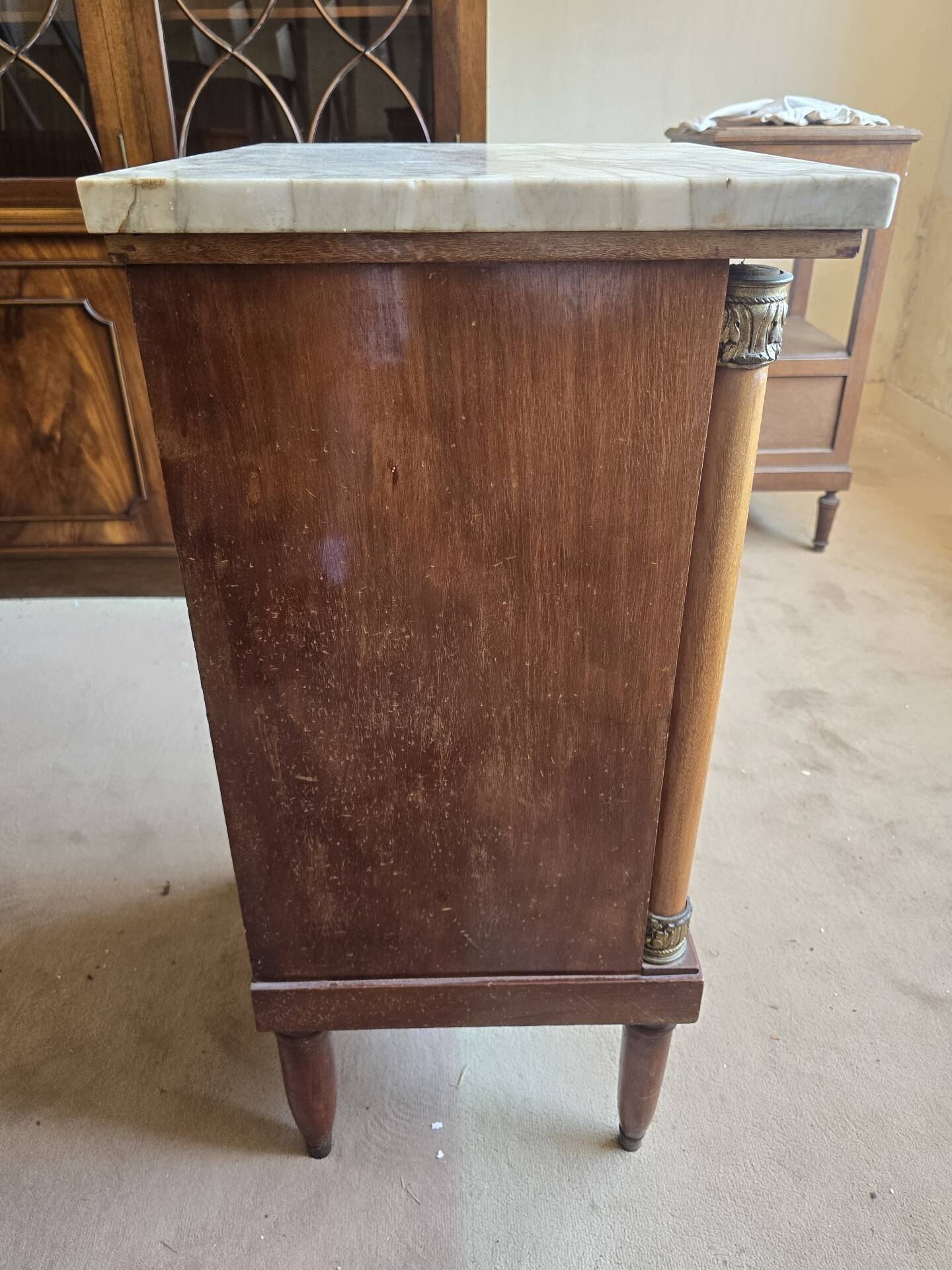 Antique Empire-style bedside table with marble top.