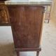 Antique Empire-style bedside table with marble top.