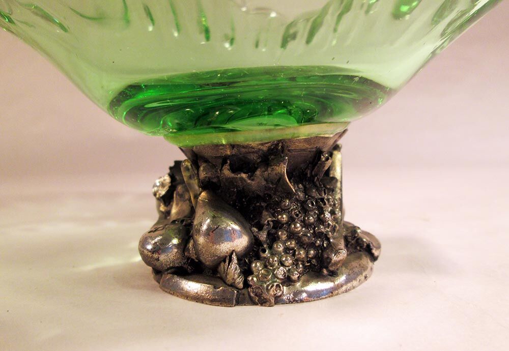Glass cup on decorated metal stand