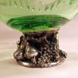 Glass cup on decorated metal stand