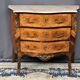 Louis XV style commode with rosewood veneer, gilded bronze mounts, and marble top.