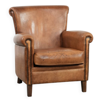Beautiful vintage armchair made of sheepskin leather with character