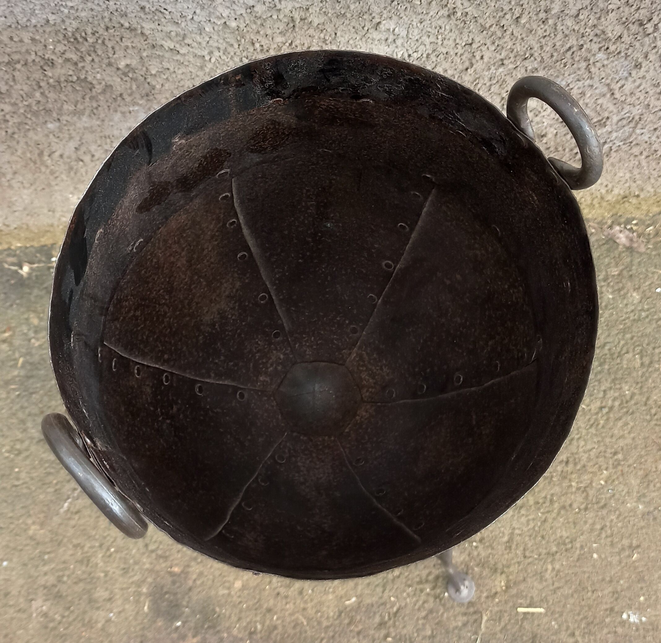 Old metal pot on foot