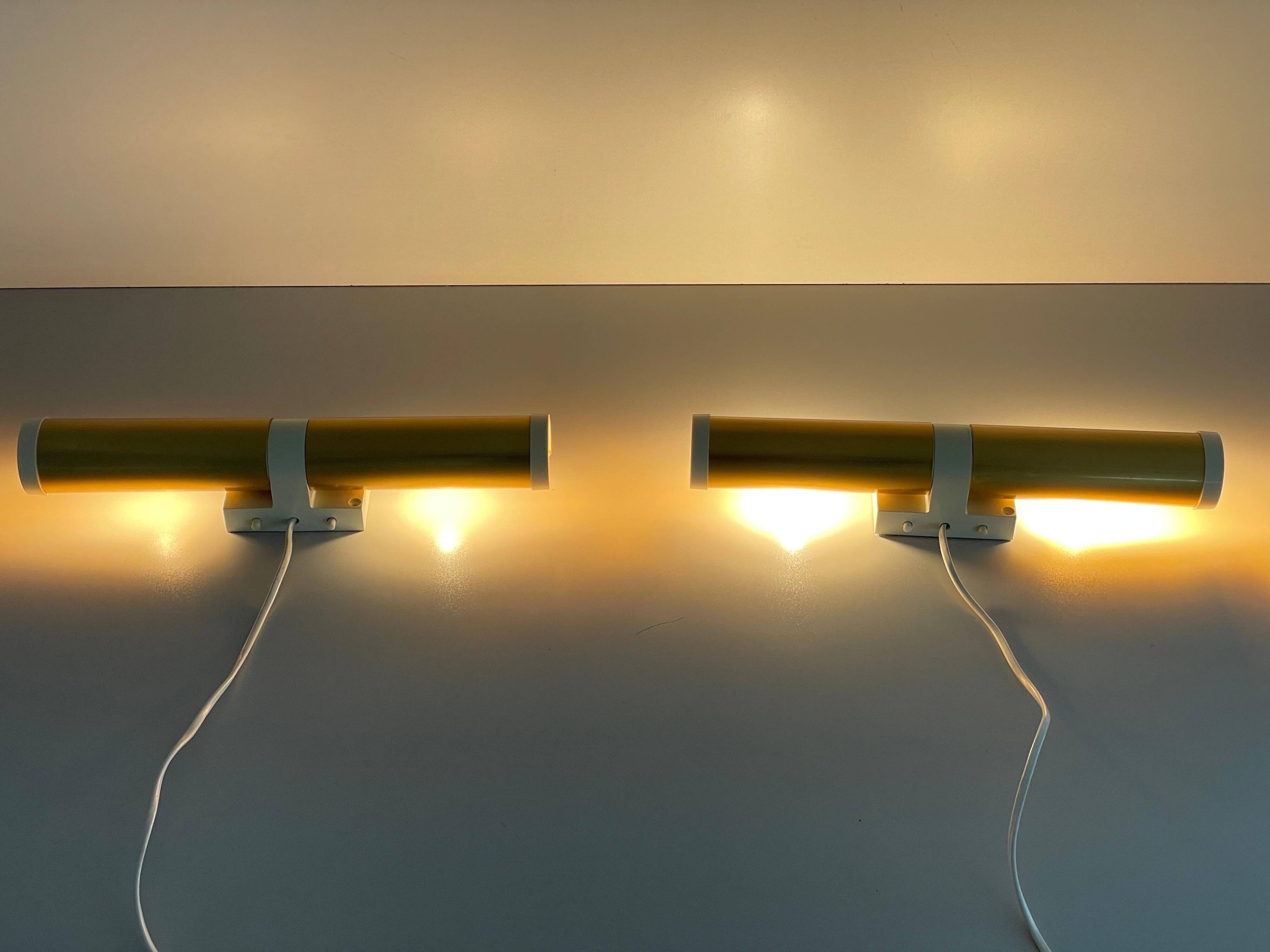 Pair of two-headed wall sconces in gold metal by ERCO, 1970s, Germany