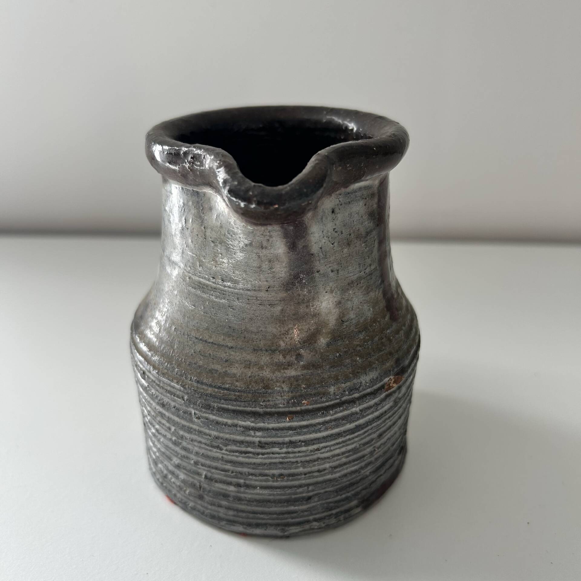 Patinated pitcher signed