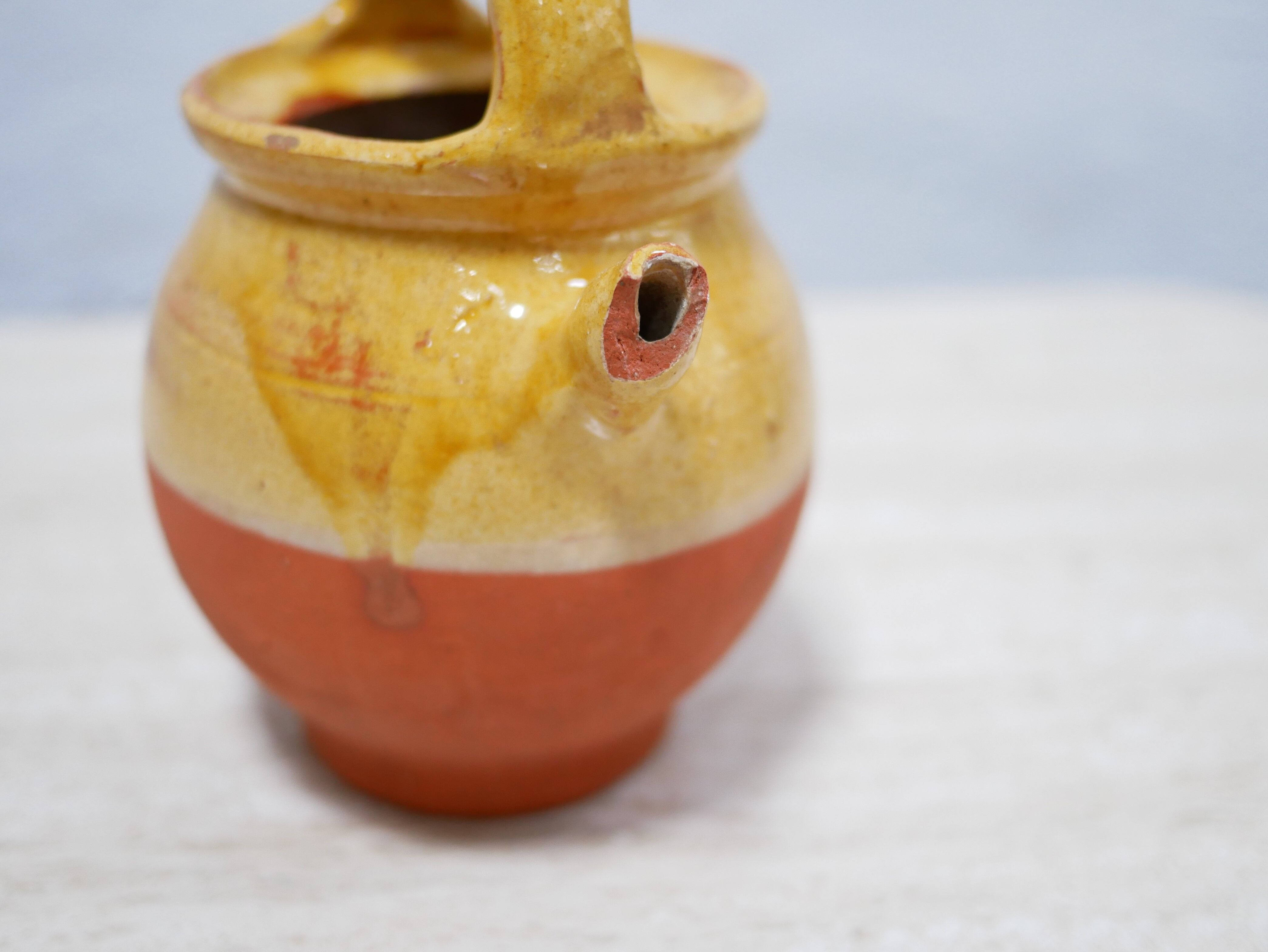 Old gargoulette pot in glazed terracotta