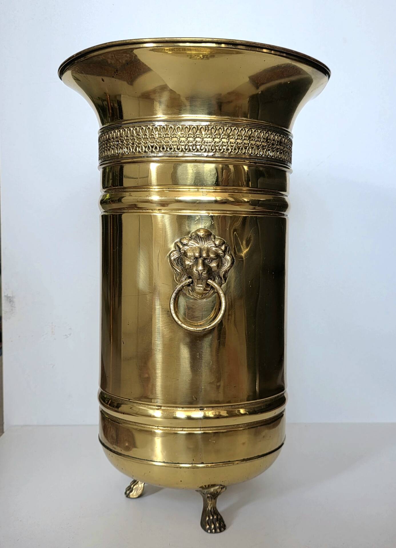 Hollywood Regency style umbrella stand, brass finish and lio pattern.