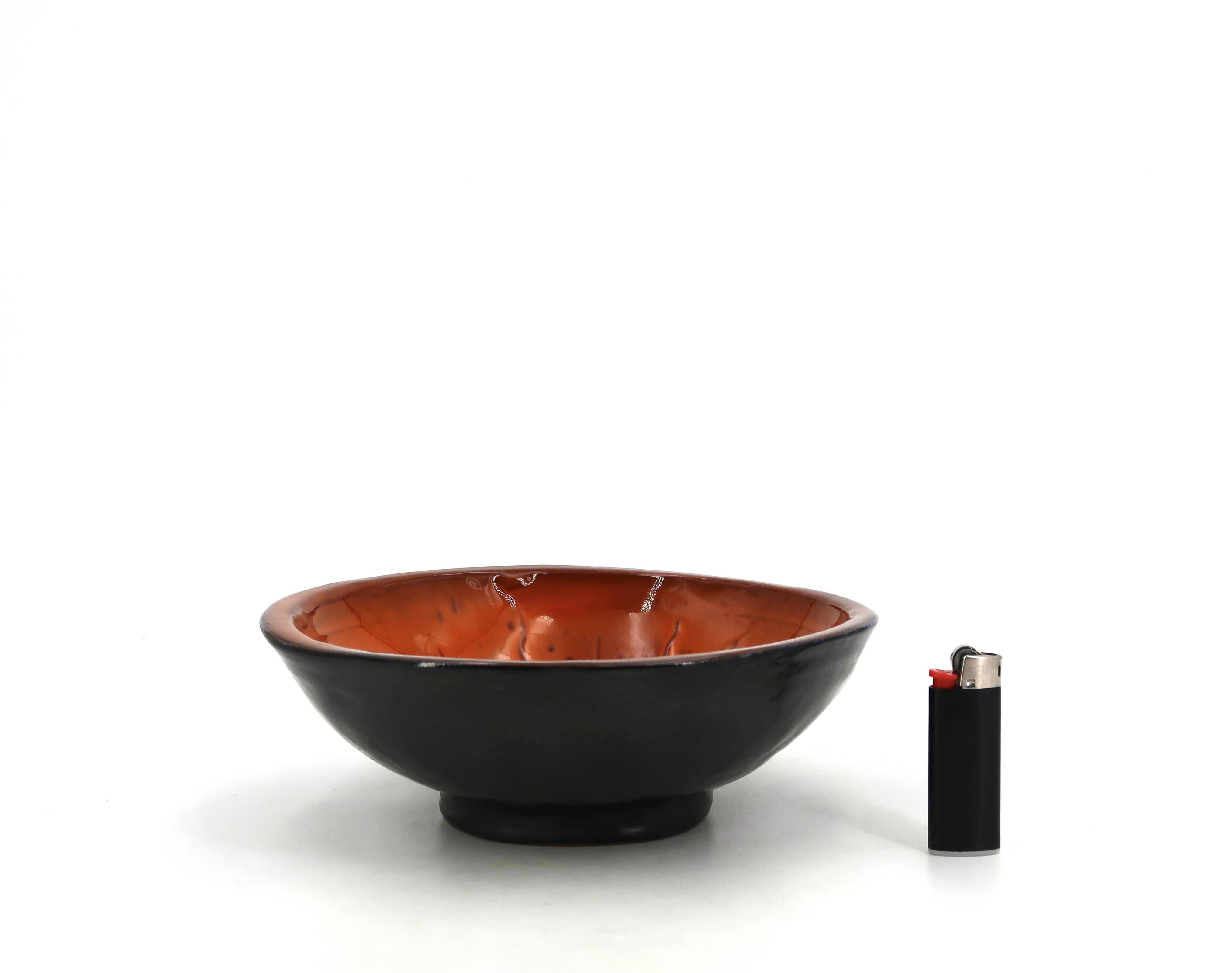 Mexican ceramic catchall in orange and black, 1970s sun face.
