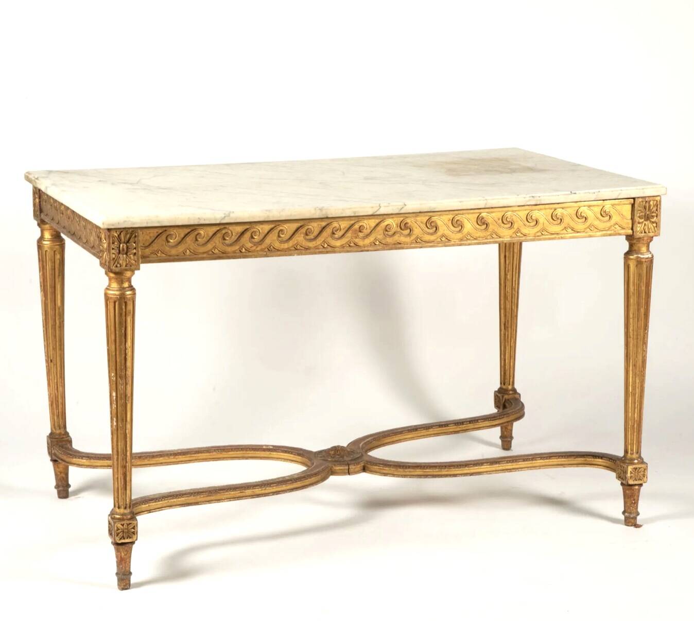 Golden carved wooden centre table with a white marble top.