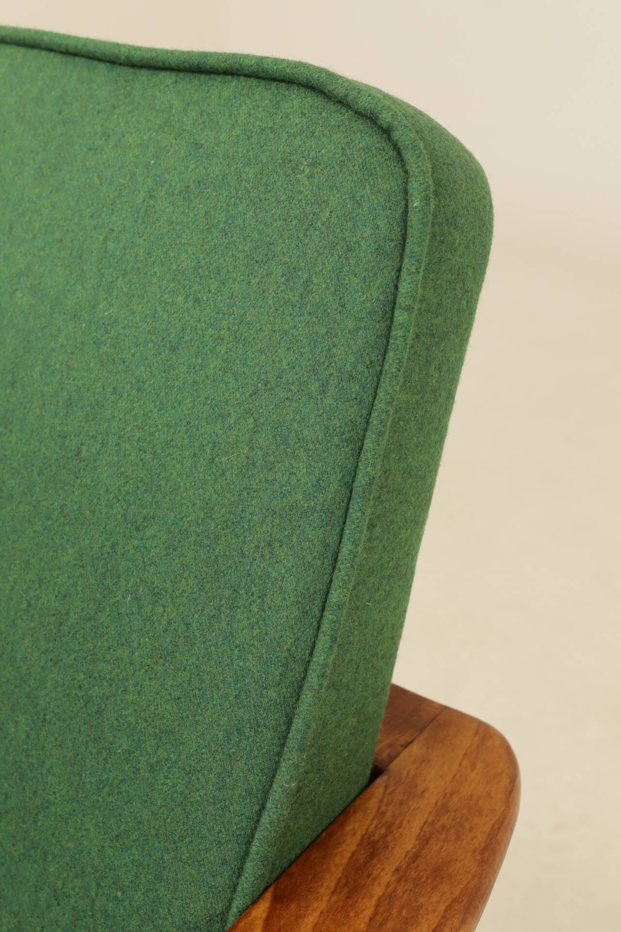 Scandinavian modern chair in green wool, vintage wooden armchair.