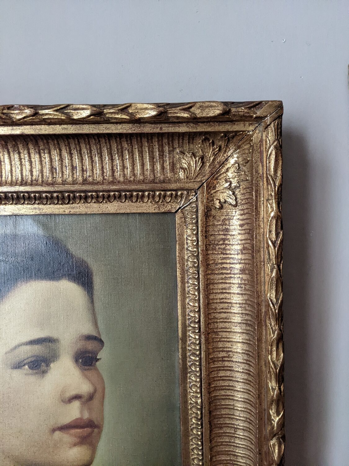 Oil on canvas portrait in an antique gilded wooden frame.