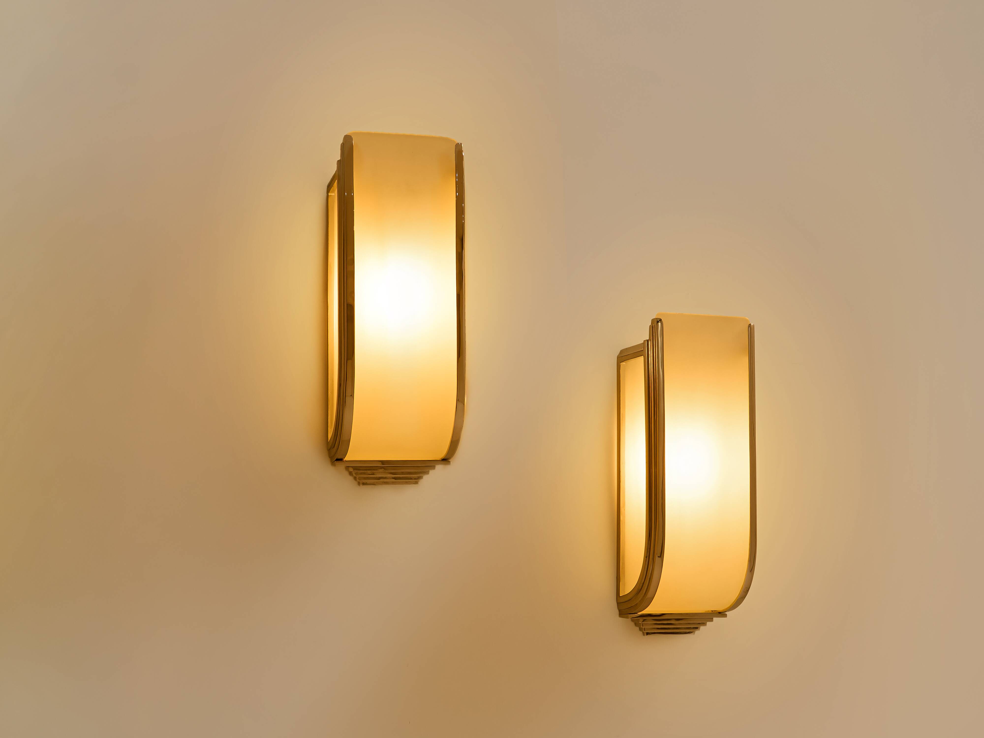 Pair of modernist wall sconces in nickel-plated steel and opaline glass, 1930.