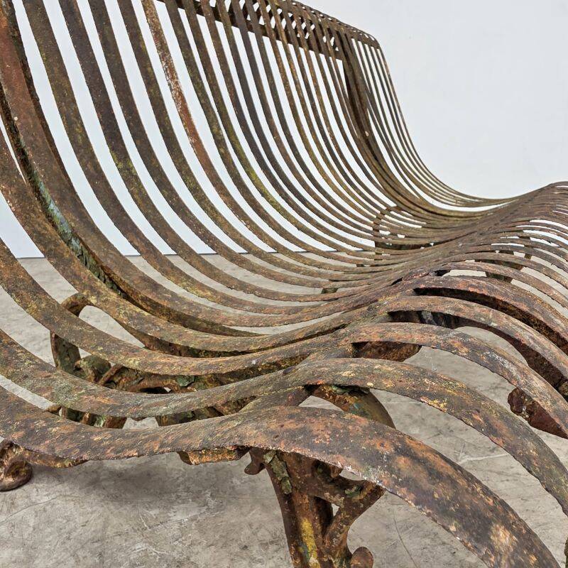 Cast iron garden bench from the late 19th century with slatted backrest.