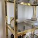 VINTAGE SHELF CONSOLE IN GOLD METAL AND SMOKED GLASS