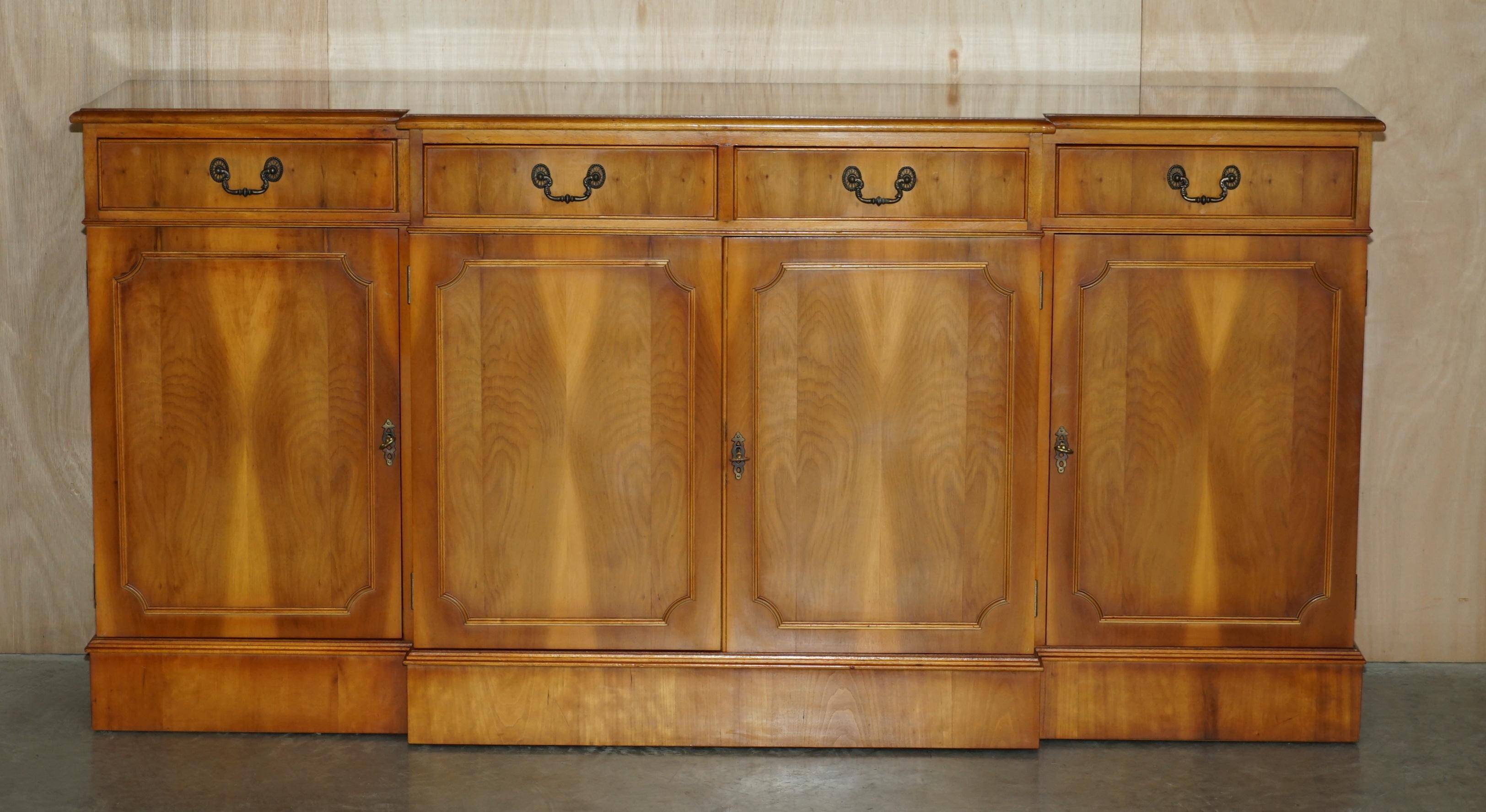 Vintage buffet made of mottled yew wood with three doors and four drawers.