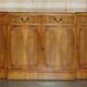 Vintage buffet made of mottled yew wood with three doors and four drawers.