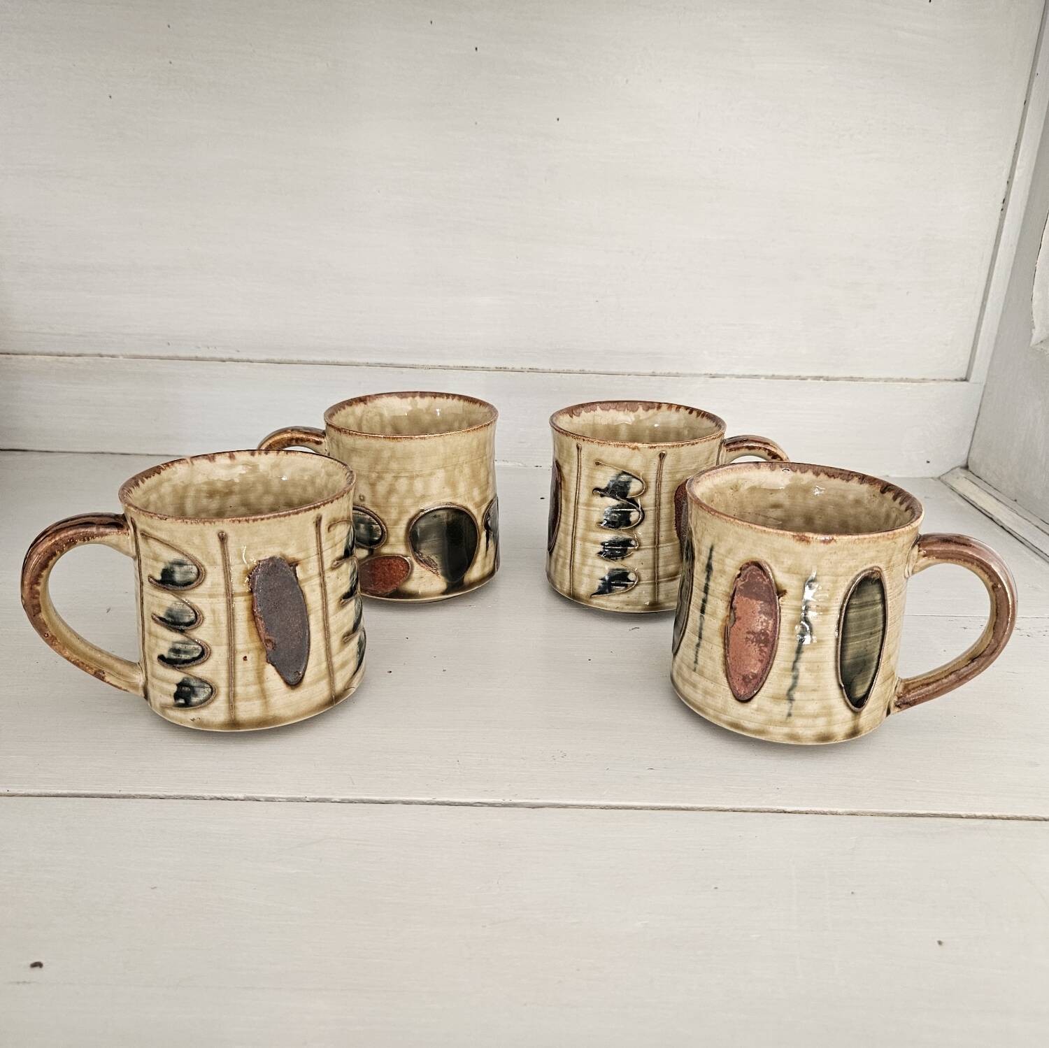 Set of 4 ceramic mugs, glazed stoneware, assorted vintage designs.