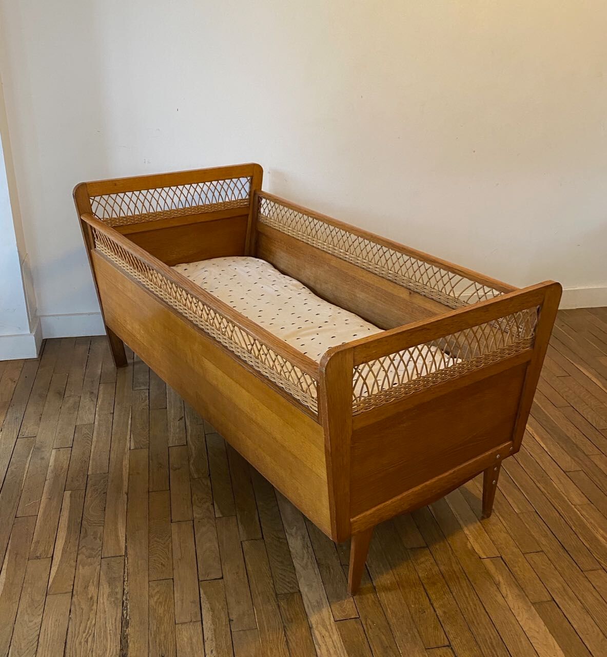 Wooden and wicker baby bed