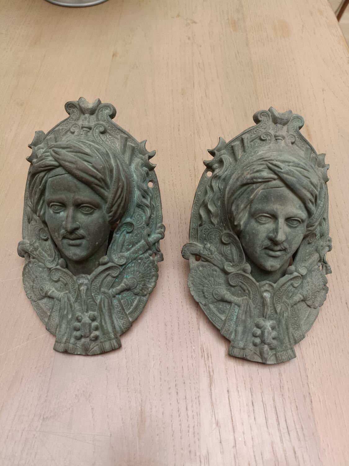 Bronze door knockers and billiard table corners