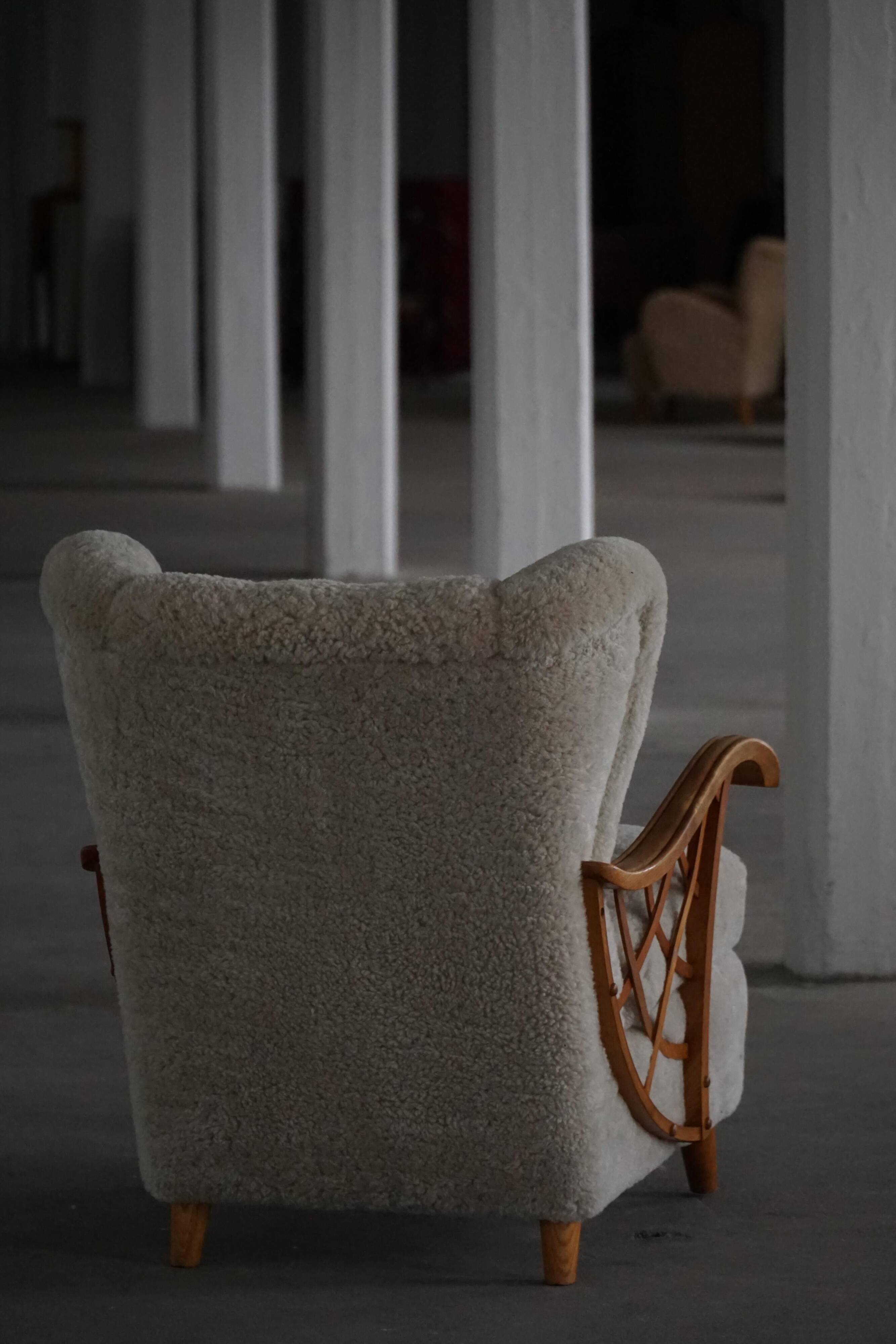 Pair of modern Swedish lounge chairs, shearling sheepskin and elm, 1940s.