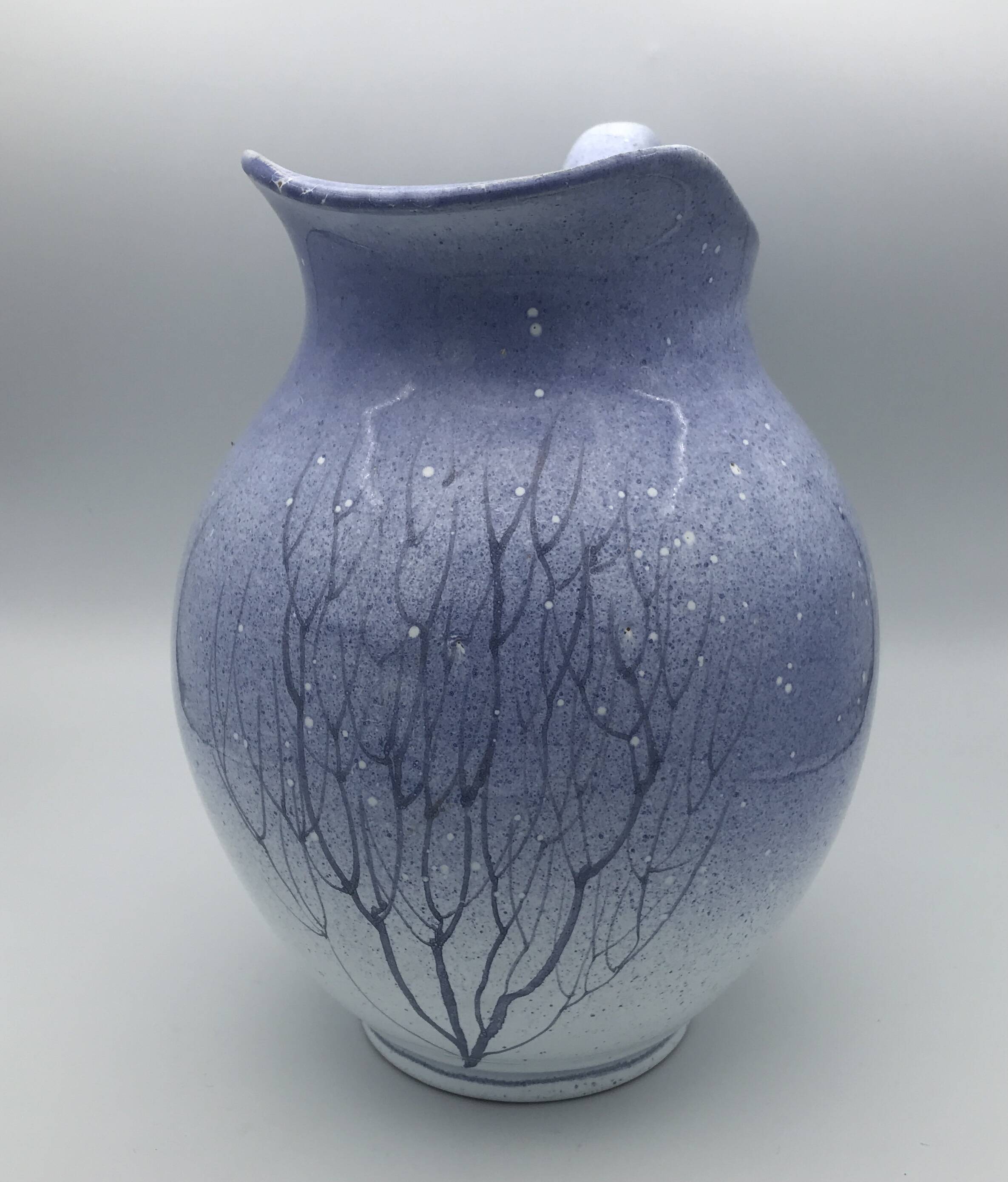 Blue glazed terracotta pitcher with hand-painted decoration, signed