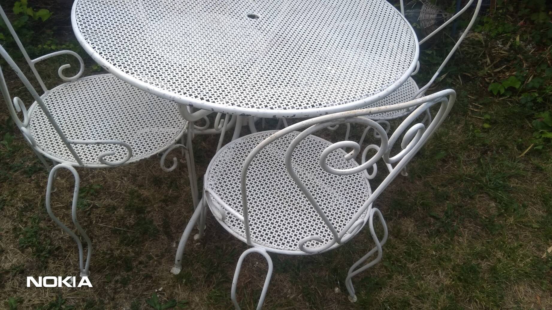 Mategot-style perforated wrought iron garden furniture with table and armchairs